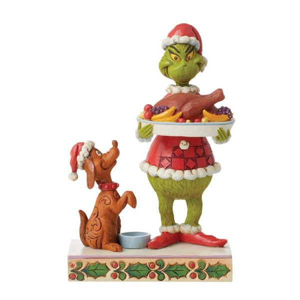 Il Grinch con la statuina della cena di Natale